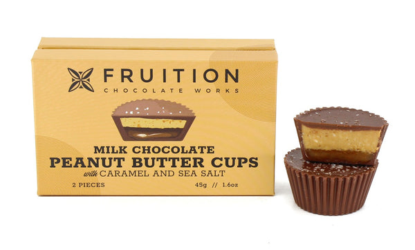 Fruition Chocolate Works milk chocolate peanut butter cups with caramel and sea salt on a white background