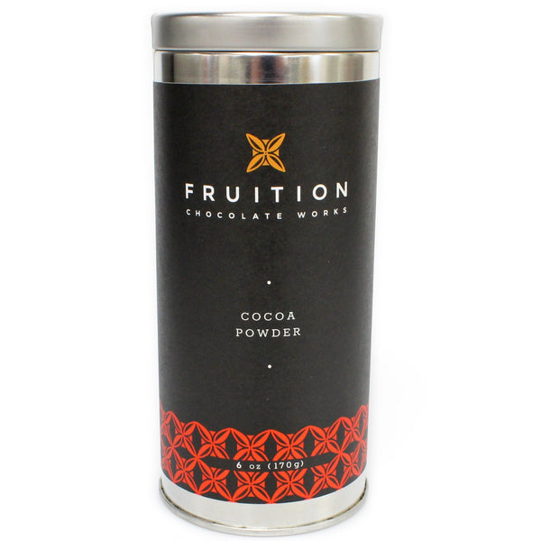tall narrow metal tin with a black label with red pattern along the bottom. The label reads "fruition chocolate works: cocoa powder"