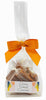 Bag of chewy salted caramels with an orange bow on a white background