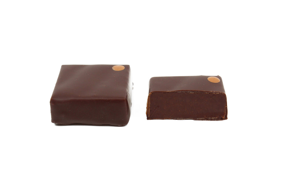 Two chocolate squares with bronze dot on the upper right corner. Manhattan rye flavor